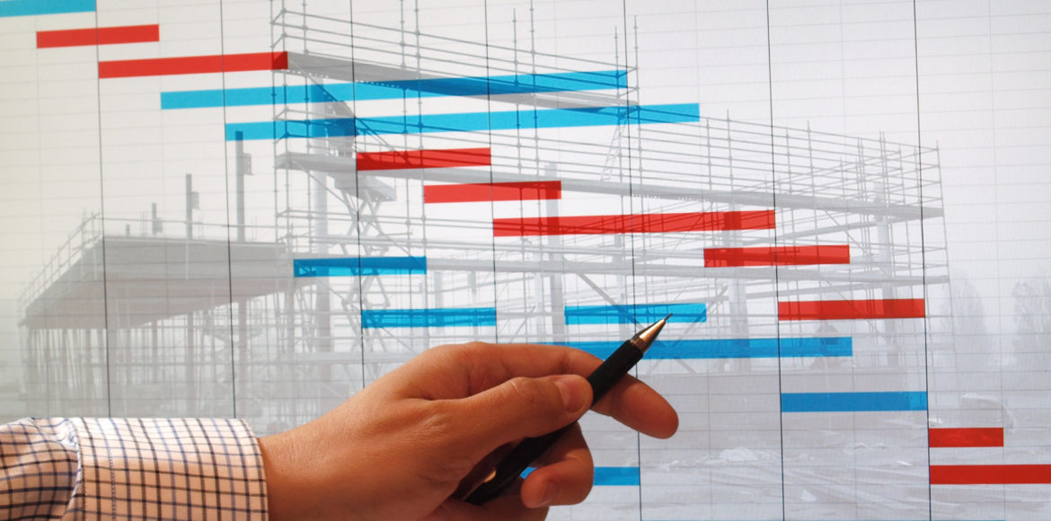 engineer studying time chart gantt diagram over building construction image